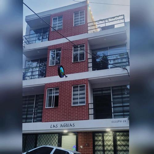 a traffic light in front of a red brick building at Las Aguas Inner Experience in Bogotá
