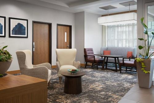 a living room with a table and chairs at Hyatt Place Boulder Pearl Street - Newly Renovated in Boulder