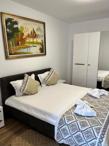 a bedroom with a bed and a painting on the wall at Casa Angy in Jurilovca