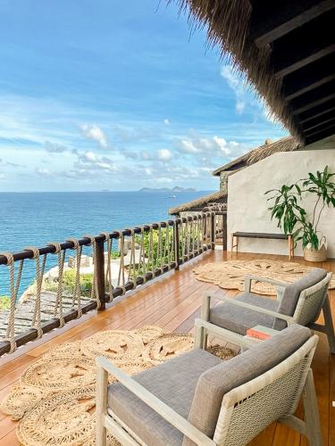 a balcony with chairs and a view of the ocean at The Aerial, BVI in Tortola Island