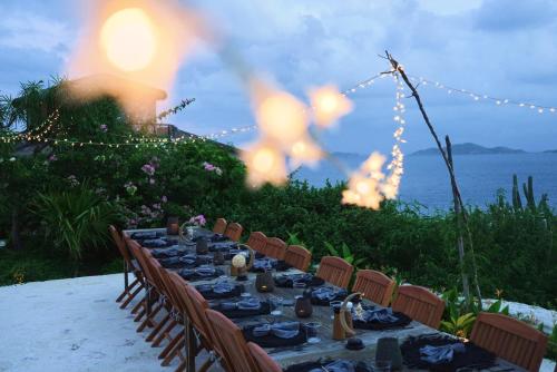 a long table with chairs and a table with at The Aerial, BVI in Tortola Island