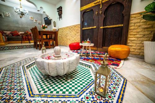 a living room with a table in the middle of a room at Authentic Agadir Riad Walk to All Sights in Agadir