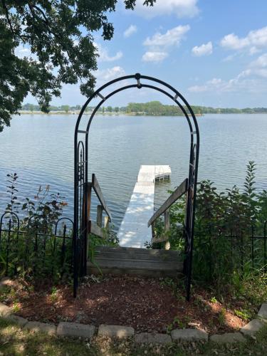 a gate leading to a dock on a lake at Over 200' of Shoreline on Foot Lake!! Great Fishing Year Round! in Willmar