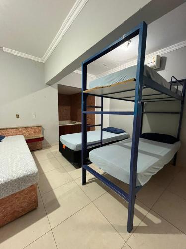 a room with two bunk beds in a room at Pousada Azul Ms in Viracopos
