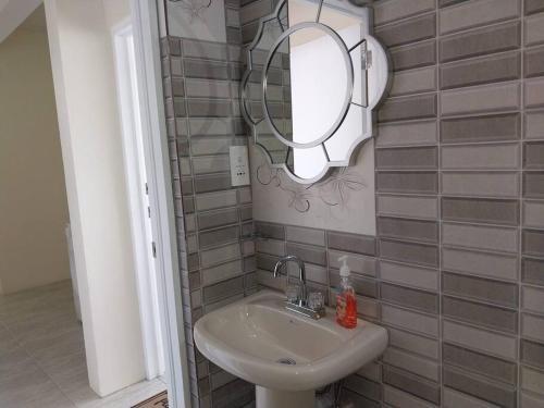 a bathroom with a sink and a mirror on the wall at Vacation Getaway at Wallhouse in Loubiere