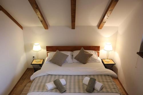 a bedroom with a large bed with two lamps at Vinea holiday home in Jakopovec