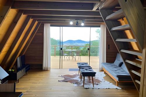 a room with a staircase and a living room at Chalé dos Alpes 2 hidromassagem e Lareira in Santo Amaro da Imperatriz