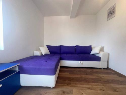 a room with a purple couch in a room at Sea View Budva in Budva