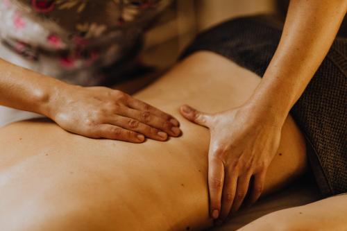 a woman getting a massage on her stomach at voco Orchard Singapore by IHG in Singapore