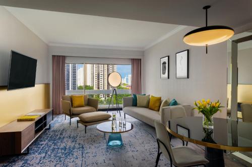 a living room with a couch and a table at voco Orchard Singapore by IHG in Singapore