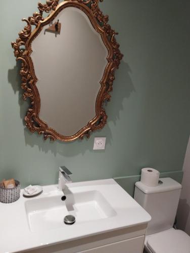 a bathroom with a sink and a mirror on the wall at Appartement piscine in Vence