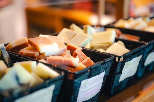a group of blocks of cheese on a table at Le Relais des Hautes Gorges in Saint Aime Des Lacs