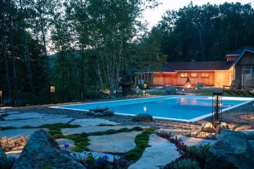 a swimming pool in the middle of a yard at Le Relais des Hautes Gorges in Saint Aime Des Lacs