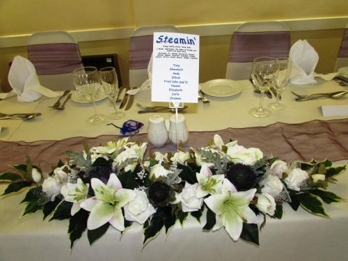 a table with a bunch of white flowers on it at The Royal Hotel Tain in Tain