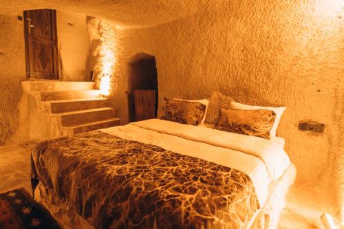 a bedroom with a bed in a room with stairs at İsadora Cave Cappadocia in Nevsehir