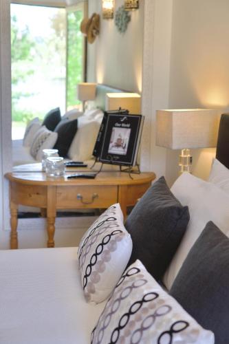 a living room with a table and a couch with pillows at Villa la Rive, River Villa in Le Temple-sur-Lot