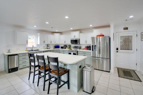 a kitchen with white cabinets and a kitchen island with bar stools at Hot Springs Retreat with Fireplace on Lake! in Hot Springs