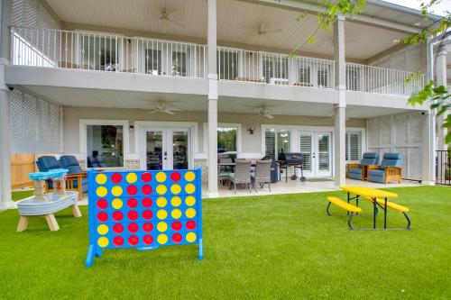an outdoor play area with a large house with a giant checker board at Hot Springs Retreat with Fireplace on Lake! in Hot Springs