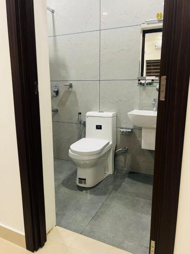 a bathroom with a toilet and a sink at The Lotaz Hotel in Cochin