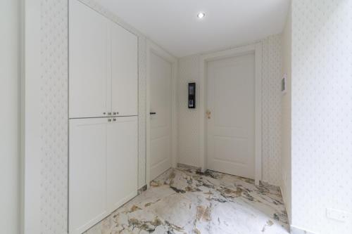 an empty room with white walls and a marble floor at Duomo Smart Suites in Milan