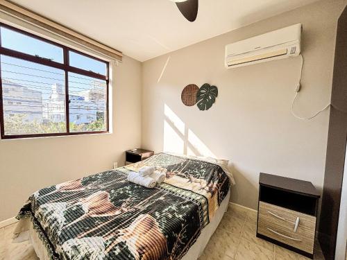 une chambre avec un lit et une fenêtre dans l'établissement Apê Família, A/C e 3 Quartos | 450m Canasvieiras, à Florianópolis