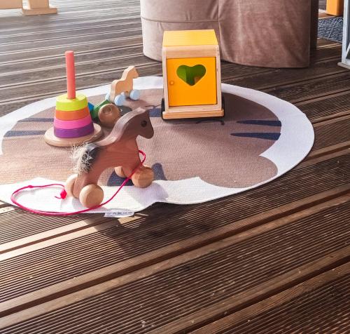 a toy horse on a rug with toys on a floor at Beskidzka Kępa Szczyrk - domek z balią i pięknym widokiem na góry in Szczyrk