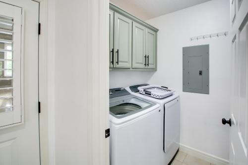 a white laundry room with a washer and dryer at Lakefront Hot Springs Condo with Balcony and Fireplace in Hot Springs