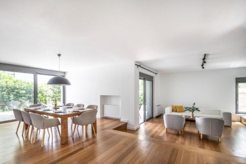 a dining room and living room with a table and chairs at Private pool Villa in Athens