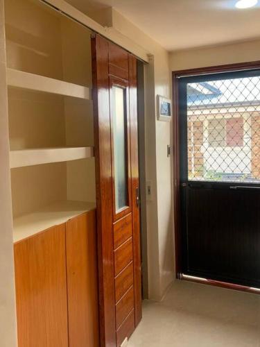 a room with a closet with a door and a window at Studio apartment in Mactan, Cebu in Mactan