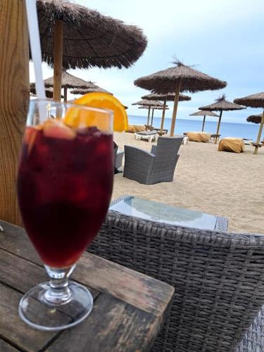 - une boisson dans un verre assis sur une table à la plage dans l'établissement T2 Rez de jardin accès direct plage, à Port-Leucate