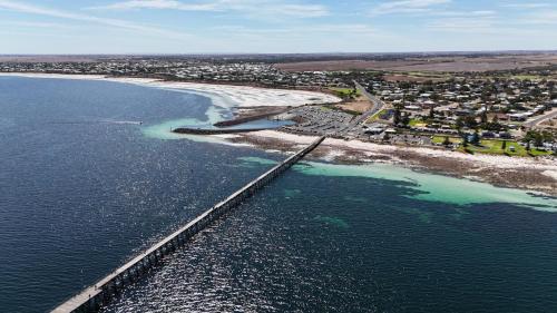 an aerial view of a bridge over the ocean at Latone Sea Lodge - Entire Home in Port Hughes in Port Hughes