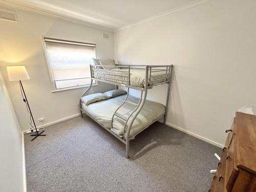 a bedroom with a bunk bed in a room at Latone Sea Lodge - Entire Home in Port Hughes in Port Hughes