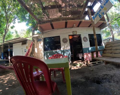 a table and chairs in front of a building at Bio Coliving Tayrona in Santa Marta