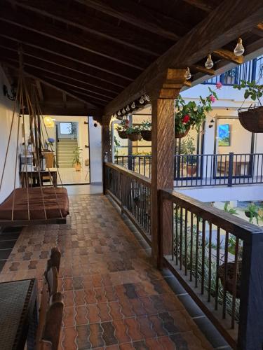 a porch of a house with a balcony at Guatapé Country House Hotel in Guatapé