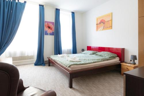 a bedroom with a bed and blue drapes at Ostarrichi in Vienna