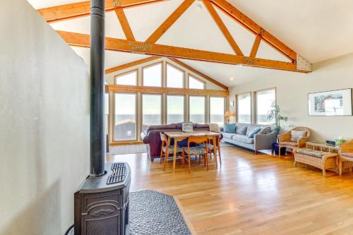 a living room with a wood stove and a dining room at Walk to Beach Oregon Coast Escape with Hot Tub! in Lincoln City