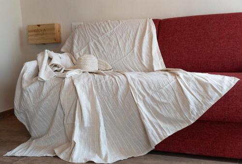 a bed with a blanket and a hat on it at ByVigin in Magliano Alfieri