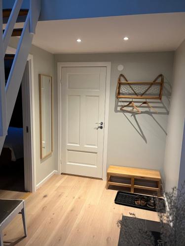 a room with a staircase and a white door at Hasselbacken in Rejmyre