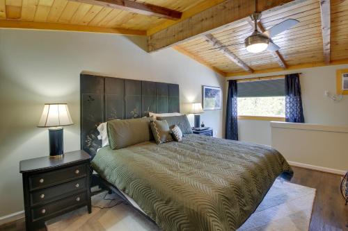 a bedroom with a large bed with a wooden ceiling at Hot Springs Cabin w/ Deck + Mountain Views! in Hot Springs