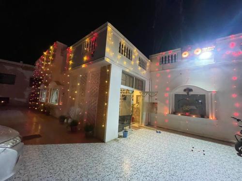 a house with christmas lights on it at night at Olive Home Stay in Agra
