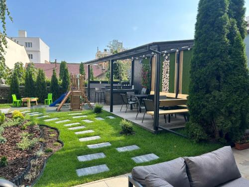 a backyard with a garden with a playground at LEO Apartment FREE PARKING - President Palace in Bratislava