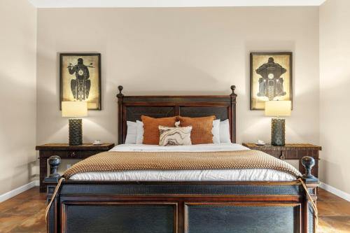 a bedroom with a large bed with two lamps at The Debonair Derby by PaseoHomesAZ with Heated Pool in Scottsdale