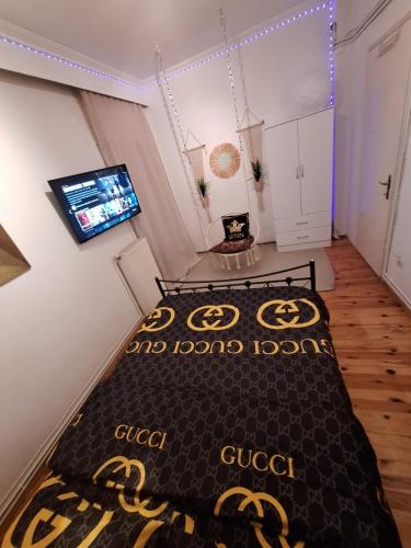 a room with a bed and a flat screen tv at Queen Suites Family Friendly 60m2 in Thessaloniki