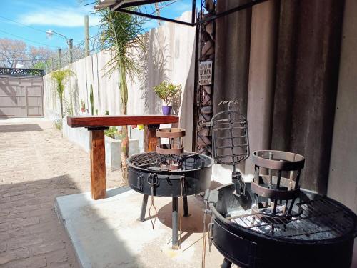 a table and chairs sitting next to a building at Vivo Urbano - Estacionamiento privado in Las Heras
