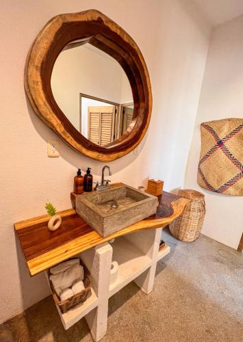 a bathroom with a wooden sink and a mirror at Puerto Escondido Pool, Beach Club, Starlink WiFi & AC in Paso Hondo