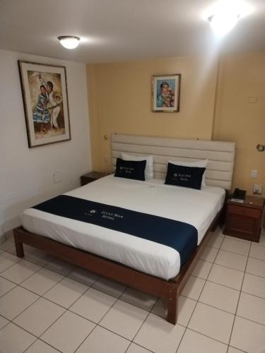 a bedroom with a large bed in a room at Lucky Star Hotel in Chiclayo