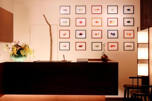 a room with a desk with a vase of flowers on the wall at Dormy Club Karuizawa in Karuizawa