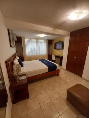 a hotel room with a bed and a tv at Lucky Star Hotel in Chiclayo