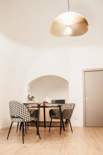 a dining room with a table and chairs at Aparthotel Camere del Capitolo in Bisceglie