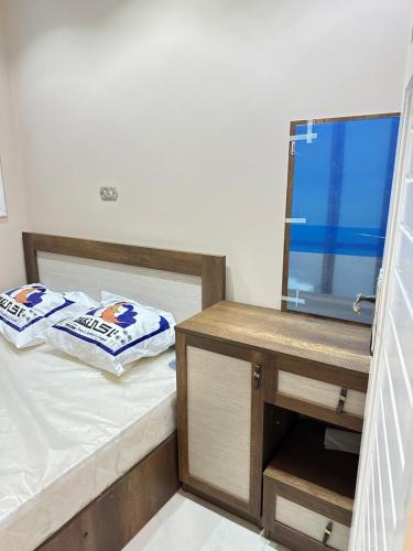 a bedroom with a bed with a desk and a tv at فيلا بحمام سباحة مارينا 6 الساحل الشمالي العلمين in El Alamein